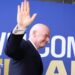 Fifa president Gianni Infantino waves while walking