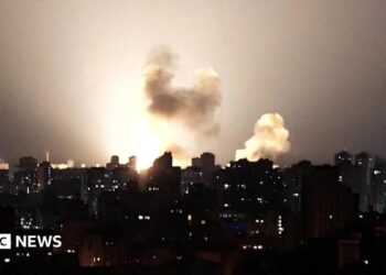Ukraine skyline at night lit up by a missile