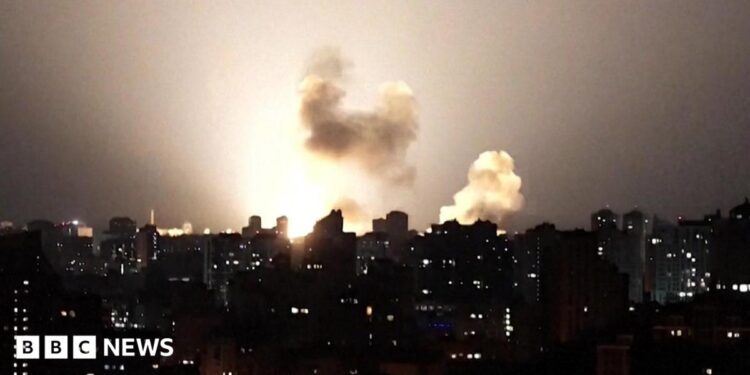 Ukraine skyline at night lit up by a missile