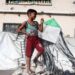 A Palestinian boy holds a kite at a displacement camp in Gaza City (23 August 2026)