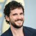 Kit Harrington seen smiling on the red carpet in a blue blazer on the red carpet in New York in May.
