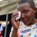 A female survivor uses a tissue to wipe tears from her eyes during a memorial service held for victims of the capsized ferry at Nyamhunga Stadium in Kariba - 13 August 2026