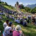 Hundreds of people gather on the slopes below Vaduz Castle, the palace and official residence of the Prince of Liechtenstein, during its National Day celebrations in Vaduz, on 15 August. Mountains can be seen in the background.