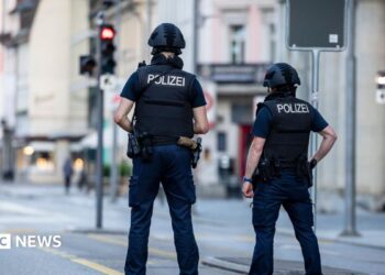 Police officers patroll a street in downtown Aarau