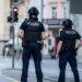Police officers patroll a street in downtown Aarau