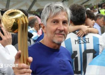 Jorge Messi holding his son Lionel Messi's trophy for best player at the 2022 World Cup after Argentina beat France in the final in Qatar