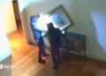A still from CCTV footage shows two thieves taking artwork off a wall inside a museum in Italy.
