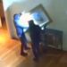 A still from CCTV footage shows two thieves taking artwork off a wall inside a museum in Italy.