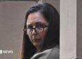 Erin Patterson during trial in Melbourne wearing glasses and her dark her down.