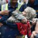 Rescuers transport an elderly woman rescued from flooded area