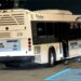 shuttle bus rests against a concrete barrier after the crash