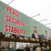 Billboard displays leaders following the signing of the Makkah Joint Defence Agreement, in Karachi