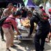 Police officers help move a patient to an open-area shelter at a hospital, following an earthquake felt in Labuan Bajo, East Nusa Tenggara province