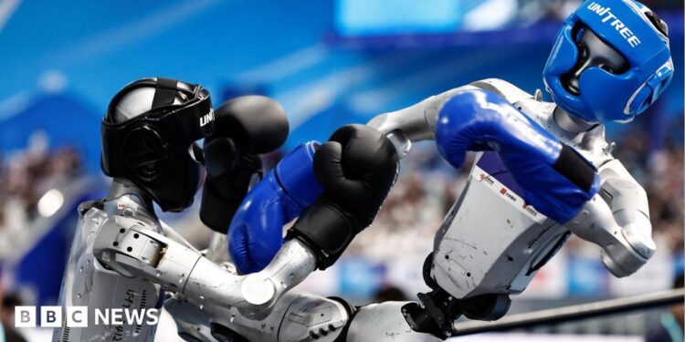 Humanoid robots by Unitree Robotics compete in the 80 kg class kickboxing quarterfinals during the 2026 World Humanoid Robot Games, at the National Speed Skating Oval, in Beijing, China August 23, 2026.