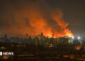 A fire breaks out following massive Russian ballistic missile strikes in the Ukrainian capital of Kyiv, with orange and black plumes of smoke expanding across the night sky.