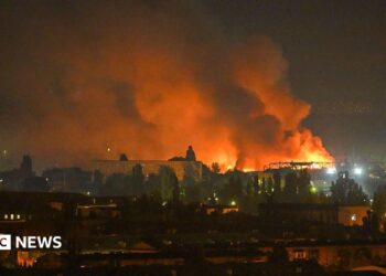 A fire breaks out following massive Russian ballistic missile strikes in the Ukrainian capital of Kyiv, with orange and black plumes of smoke expanding across the night sky.