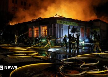 Firefighters work at a site hit by a Russian missile strike, amid Russia's attack on Ukraine, in Kyiv on 20 August.