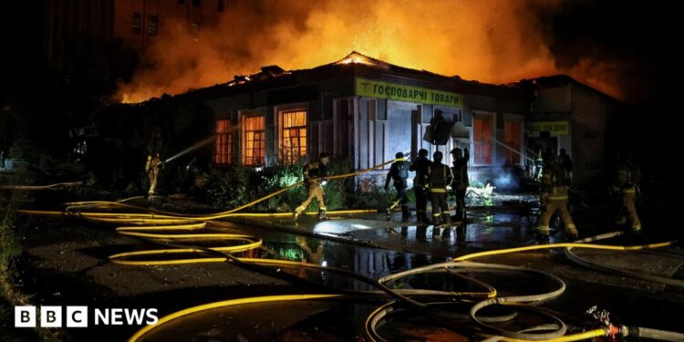 Firefighters work at a site hit by a Russian missile strike, amid Russia's attack on Ukraine, in Kyiv on 20 August.