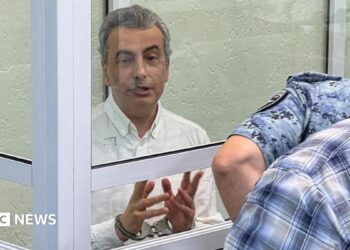 Lev Shlosberg (left, in handcuffs) attends a court hearing in Pskov, western Russia. Photo: 17 September 2026.