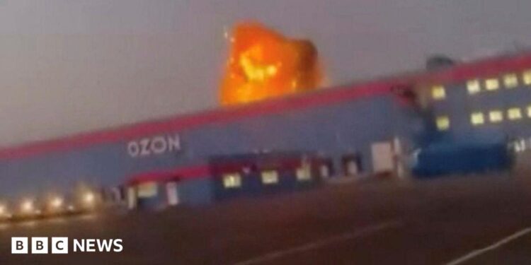 A screengrab from a video on social media showing flames rise from an Ozon facility following a Ukrainian drone strike in Makhachkala, Dagestan, Russia.