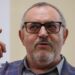Boris Nadezhdin, who has short grey hair, wears a colourful blazer and glasses in court in Dolgoprudny, Moscow region, last month. He is pointing upwards with his right index finger.