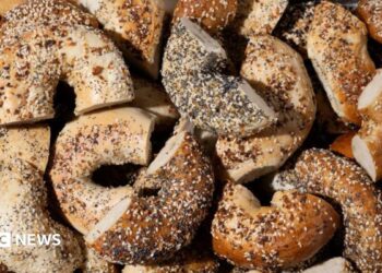 Everything bagels baked with a mix of toppings including garlic flakes, onion flakes, poppy seeds, sesame seeds and salt
