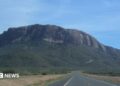 Mount Ololokwe is seen in the background of a highway