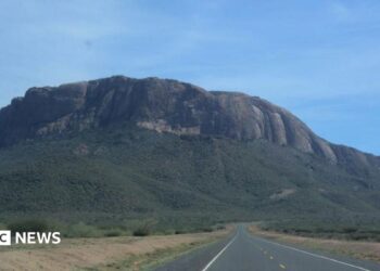 Mount Ololokwe is seen in the background of a highway