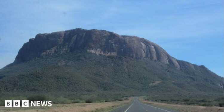 Mount Ololokwe is seen in the background of a highway