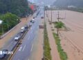 Cars pass through a severely flooded highway in Geoje, Gyeongsang, South Korea