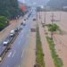 Cars pass through a severely flooded highway in Geoje, Gyeongsang, South Korea
