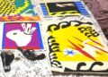 The Matisse illustrations - bold cut out collages in primary colours and black - are pictured laid out on a bed, alongside a handgun