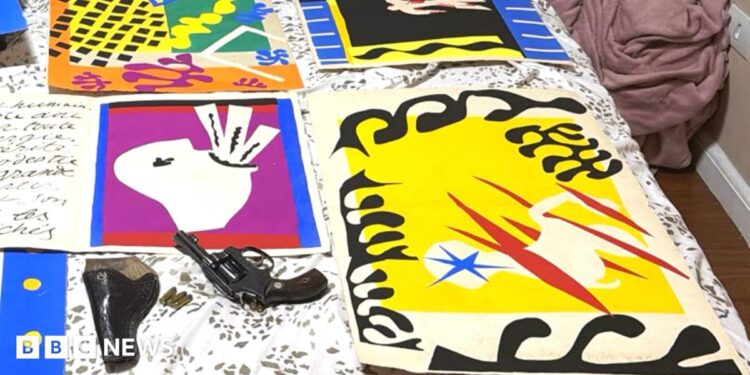 The Matisse illustrations - bold cut out collages in primary colours and black - are pictured laid out on a bed, alongside a handgun