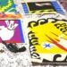 The Matisse illustrations - bold cut out collages in primary colours and black - are pictured laid out on a bed, alongside a handgun