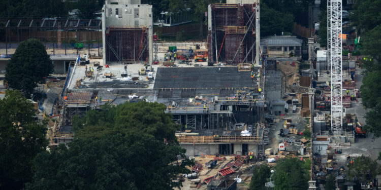 Workers continue construction of a helipad and Ballroom on the South Lawn of the White House