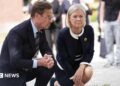 Swedish Prime Minister Ulf Kristersson (L) and Social Democratic Party leader Magdalena Andersson visit the makeshift memorial.