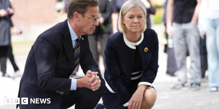 Swedish Prime Minister Ulf Kristersson (L) and Social Democratic Party leader Magdalena Andersson visit the makeshift memorial.