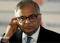 N Chandrasekaran, wearing a dark suit, white shirt and thick-rimmed glasses, touches his ear in this photo taken at the Bombay Stock Exchange in Mumbai, India, on November 12, 2025.