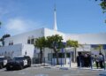 People gather near police vehicles outside the Islamic Center of San Diego.