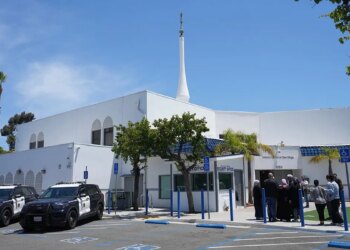 People gather near police vehicles outside the Islamic Center of San Diego.
