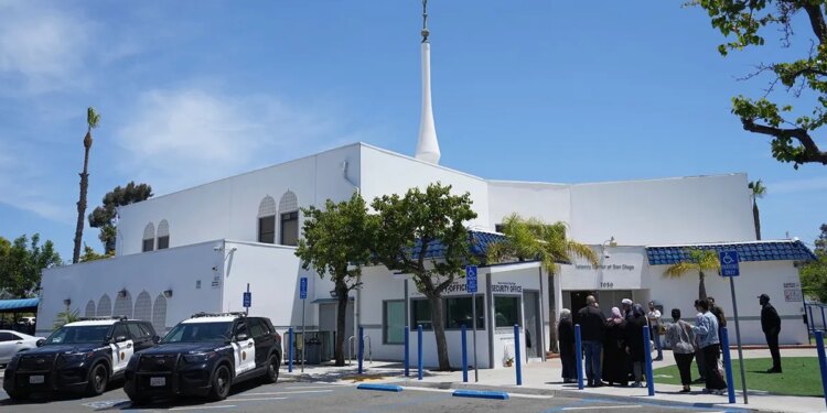 People gather near police vehicles outside the Islamic Center of San Diego.