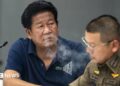 Chalong blows smoke through his nose
