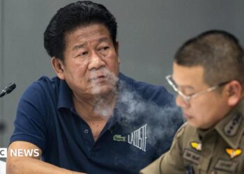 Chalong blows smoke through his nose