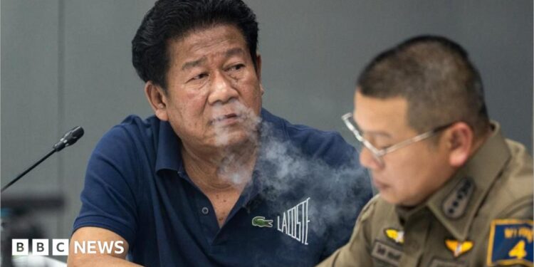 Chalong blows smoke through his nose