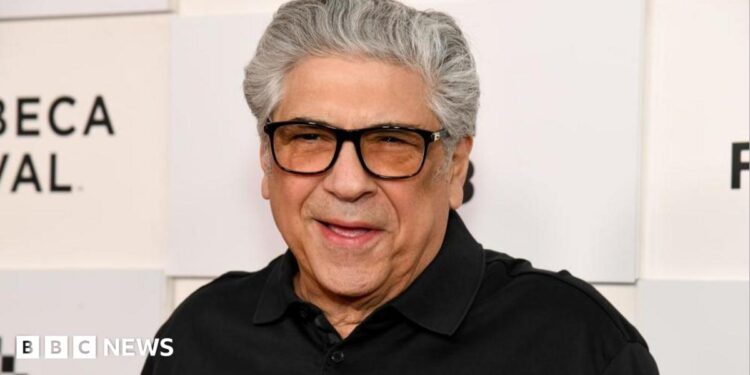 Vincent Pastore wears a black polo shirt and black-rimmed glasses.