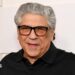 Vincent Pastore wears a black polo shirt and black-rimmed glasses.