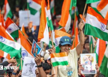 Supporters of the youth-led satirical political movement Cockroach Janta Party (CJP) celebrate the resignation of Union Education Minister Dharmendra Pradhan, in Mumbai, India