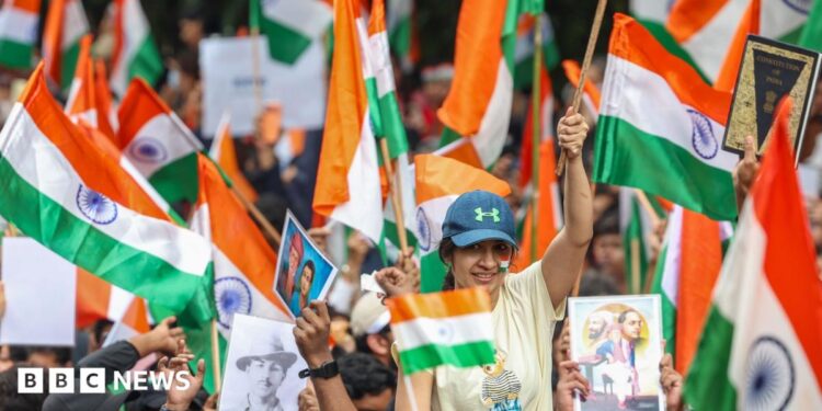Supporters of the youth-led satirical political movement Cockroach Janta Party (CJP) celebrate the resignation of Union Education Minister Dharmendra Pradhan, in Mumbai, India