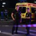 Armed Moscow police stand guard in front of an ambulance near the scene of an explosion near the centre of the city.