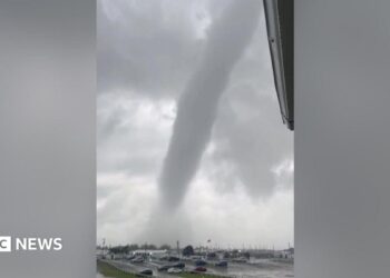 A tornado above a car park.